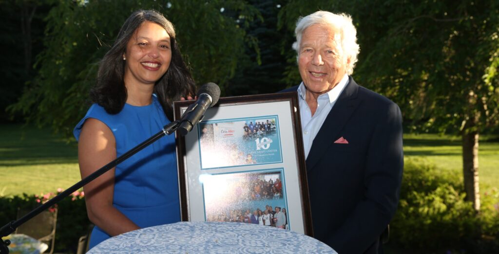 Kraft Center Executive Director Dr. Elsie Taveras (left) holds a 10th anniversary plaque with Robert Kraft (right)